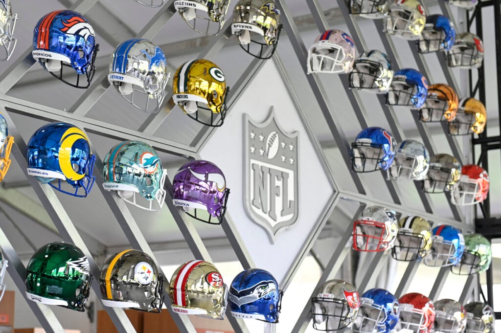 CLEVELAND, OHIO - APRIL 28: Wall of NFL team helmets on display inside the NFL Locker Room at the NFL Draft Experience on April 28, 2021 in Cleveland, Ohio.