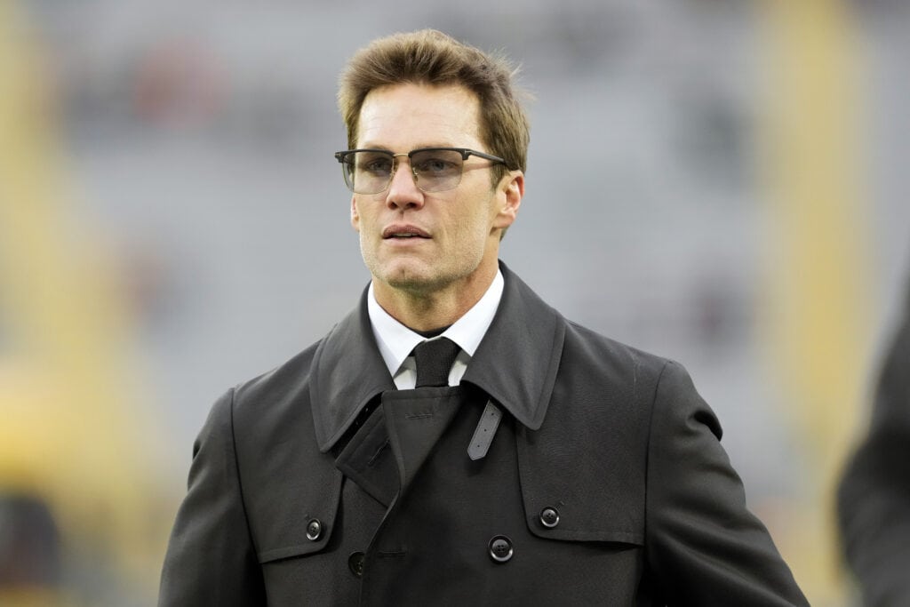 GREEN BAY, WISCONSIN - NOVEMBER 24: Tom Brady walks across the field before the game between the San Francisco 49ers and the Green Bay Packers at Lambeau Field on November 24, 2024 in Green Bay, Wisconsin.