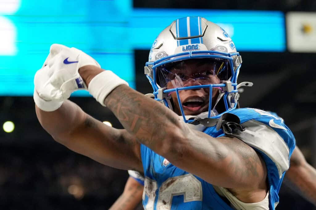 DETROIT, MICHIGAN - DECEMBER 05: Jahmyr Gibbs #26 of the Detroit Lions celebrates after scoring a touchdown against the Green Bay Packers during the second quarter in the game at Ford Field on December 05, 2024 in Detroit, Michigan.