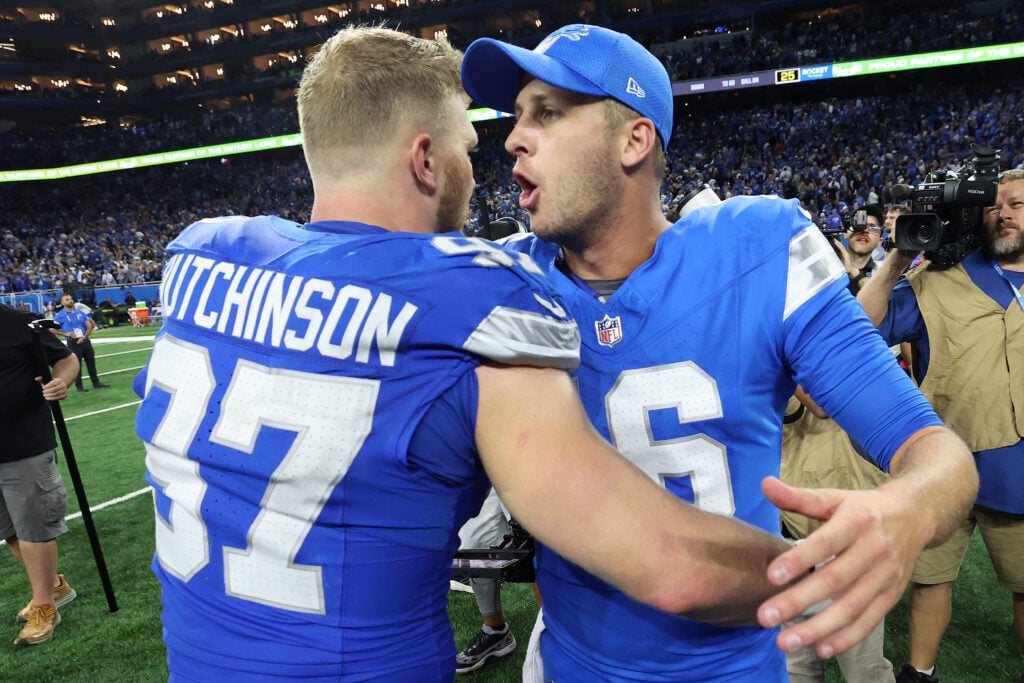DETROIT, MICHIGAN - SEPTEMBER 08: Jared Goff #16 and Aidan Hutchinson #97 of the Detroit Lions celebrate defeating the Los Angeles Rams 26-20 in overtime at Ford Field on September 08, 2024 in Detroit, Michigan.