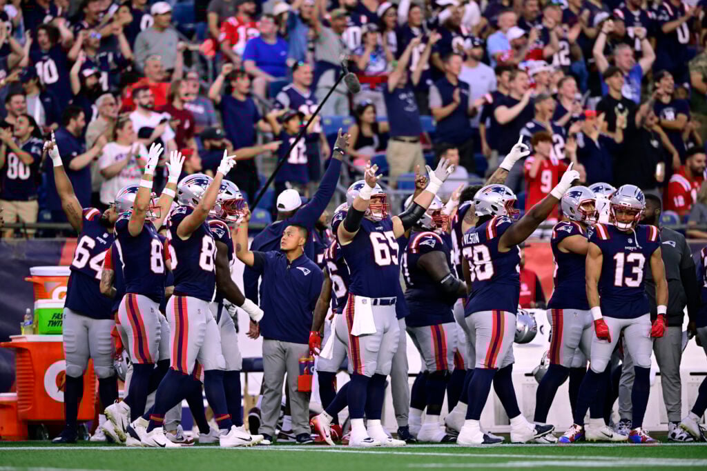 FOXBOROUGH, MASSACHUSETTS - AUGUST 08: Members of the New England Patriots react as TreVeyon Henderson of the New England Patriots carries the opening kickoff for a touchown in the first quarter during the NFL Preseason 2025 game against the Washington Commanders at Gillette Stadium on August 08, 2025 in Foxborough, Massachusetts.