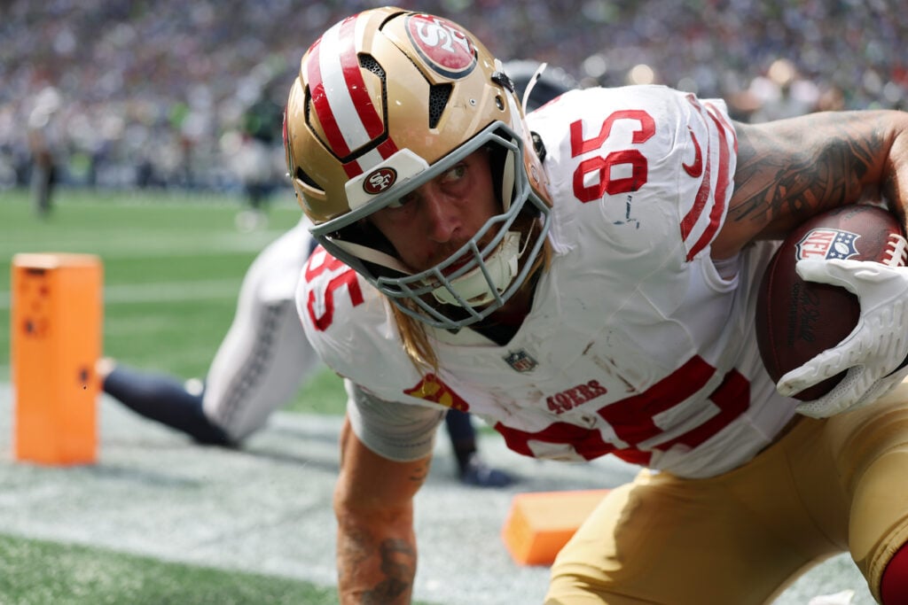SEATTLE, WASHINGTON - SEPTEMBER 07: George Kittle #85 of the San Francisco 49ers scores a touchdown against Ty Okada #39 of the Seattle Seahawks during the first quarter during the game at Lumen Field on September 07, 2025 in Seattle, Washington.