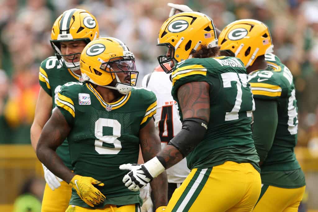 GREEN BAY, WISCONSIN - OCTOBER 12: Josh Jacobs #8 of the Green Bay Packers celebrates with teammates after his rushing touchdown against the Cincinnati Bengals during the second quarter in the game at Lambeau Field on October 12, 2025 in Green Bay, Wisconsin.