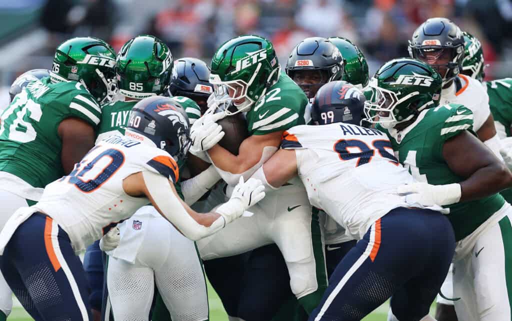 LONDON, ENGLAND - OCTOBER 12: Isaiah Oliver of New York Jets, centre, is tackled during the NFL 2025 game between Denver Broncos and New York Jets at Tottenham Hotspur Stadium on October 12, 2025 in London, England.